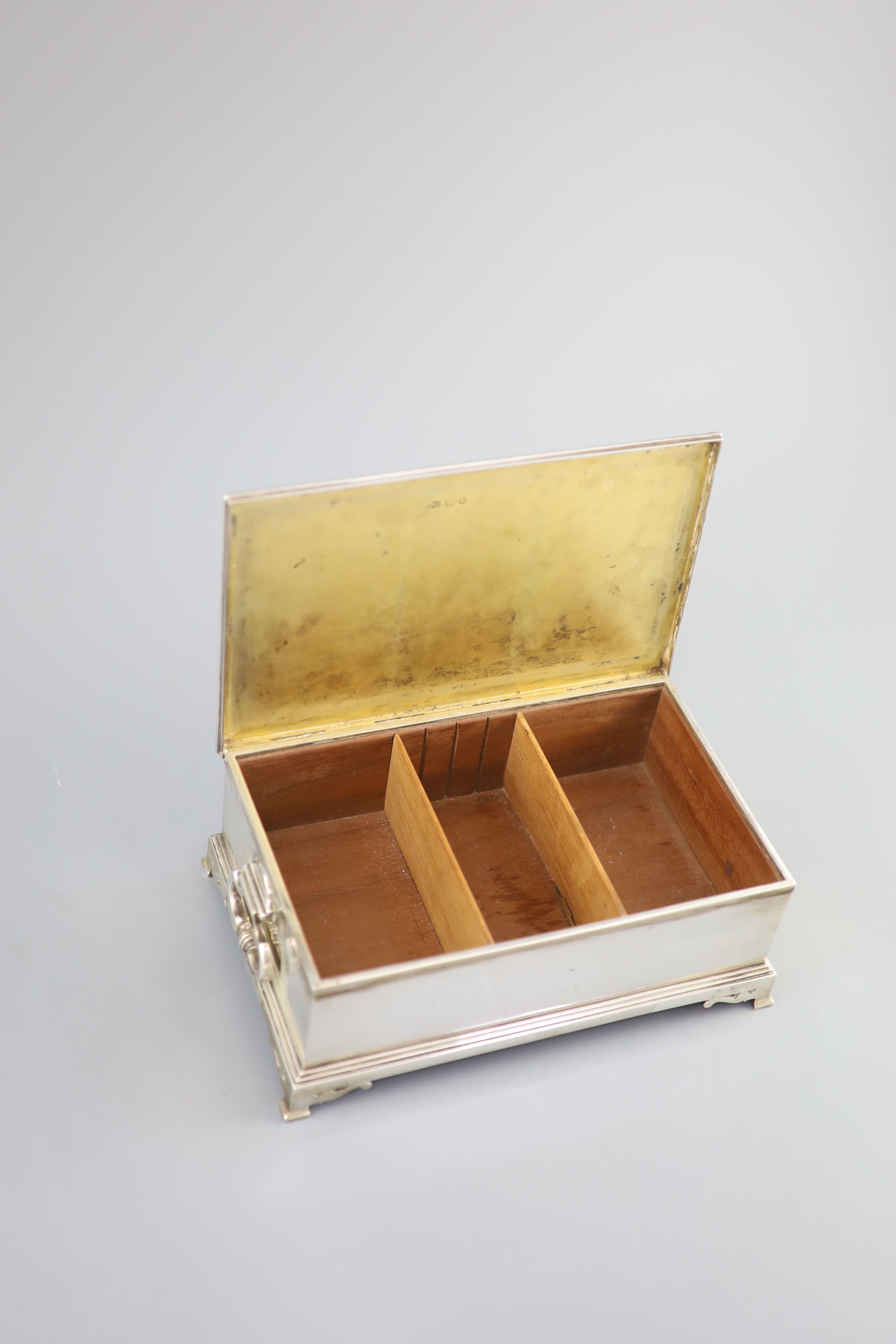 A George VI silver mounted two handled rectangular cigar box, by William Comyns & Sons Ltd, with engraved inscription relating to the Freedom of the Borough of Hove, awarded to Alexander Henry Clarke Esq.